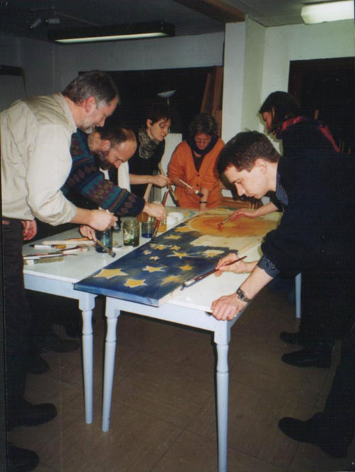 Eine Familie gestaltet gemeinsam den Sargdeckel fr den verstorbenen Grovater